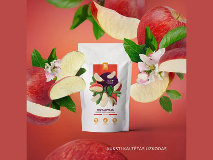 Freeze-dried apple slices in Nutriboom packaging with fresh apples and blossoms on a red background