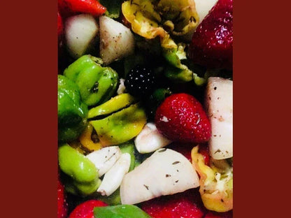Fresh salad with strawberries, blackberries, green peppers, and root vegetables