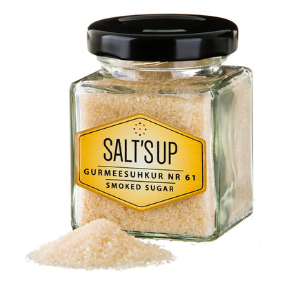 Square glass jar of Salt's Up Gurmeesuhkur Nr 61 smoked sugar with black lid and sugar pile