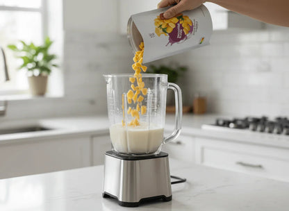 Smoothie Maker 15-Pack (15 Small Pouches) in use with blender pouring tropical smoothie blend into milk.