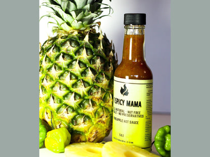 Pineapple hot sauce bottle with whole pineapple, habanero peppers, and pineapple slices