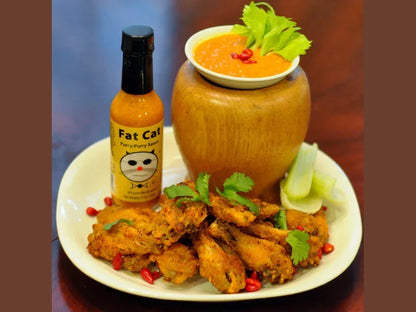 Fat Cat Purry-Purry Sauce bottle with chicken wings, celery, and dipping sauce on plate
