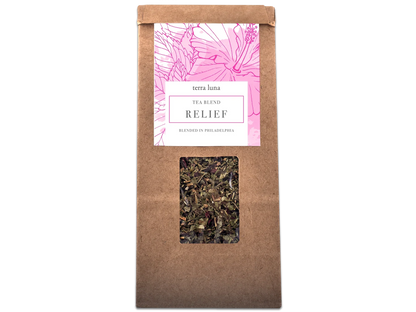 Terra Luna Relief tea blend brown kraft bag with pink botanical label and loose leaf herbs visible