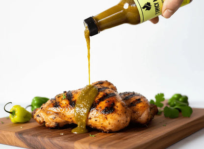 ALT A - Ultimate Heat Collection (5 Bottles) drizzle over grilled chicken with fresh herbs and green peppers.